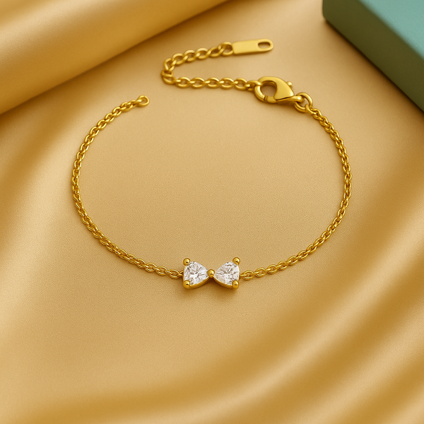 Celeste Minimal Gold Bracelet displayed on soft golden satin, delicate twin zircon design by Gwellery.
